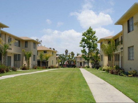 A row of houses with a pathway in the middle.