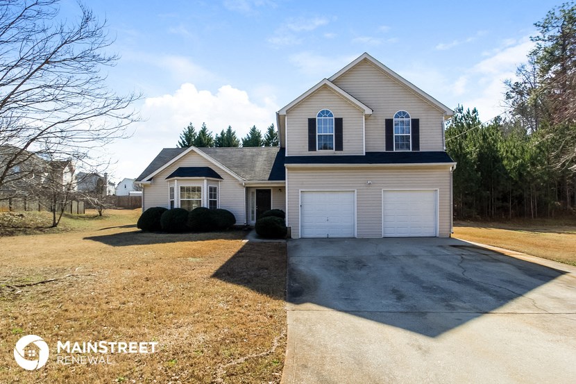a house with a driveway and a white garage door
