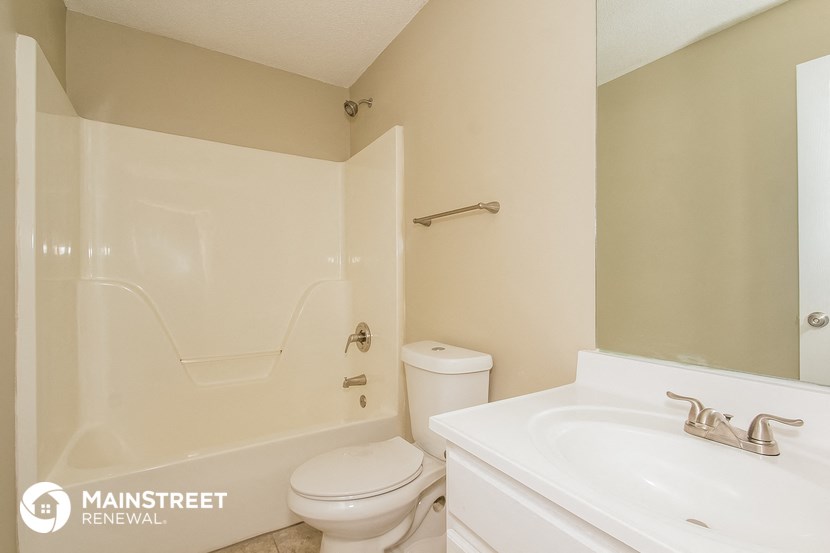 a bathroom with a toilet and a sink and a shower