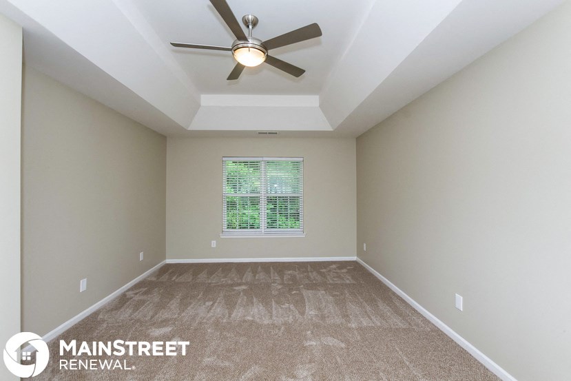 the master bedroom is spacious and has a ceiling fan