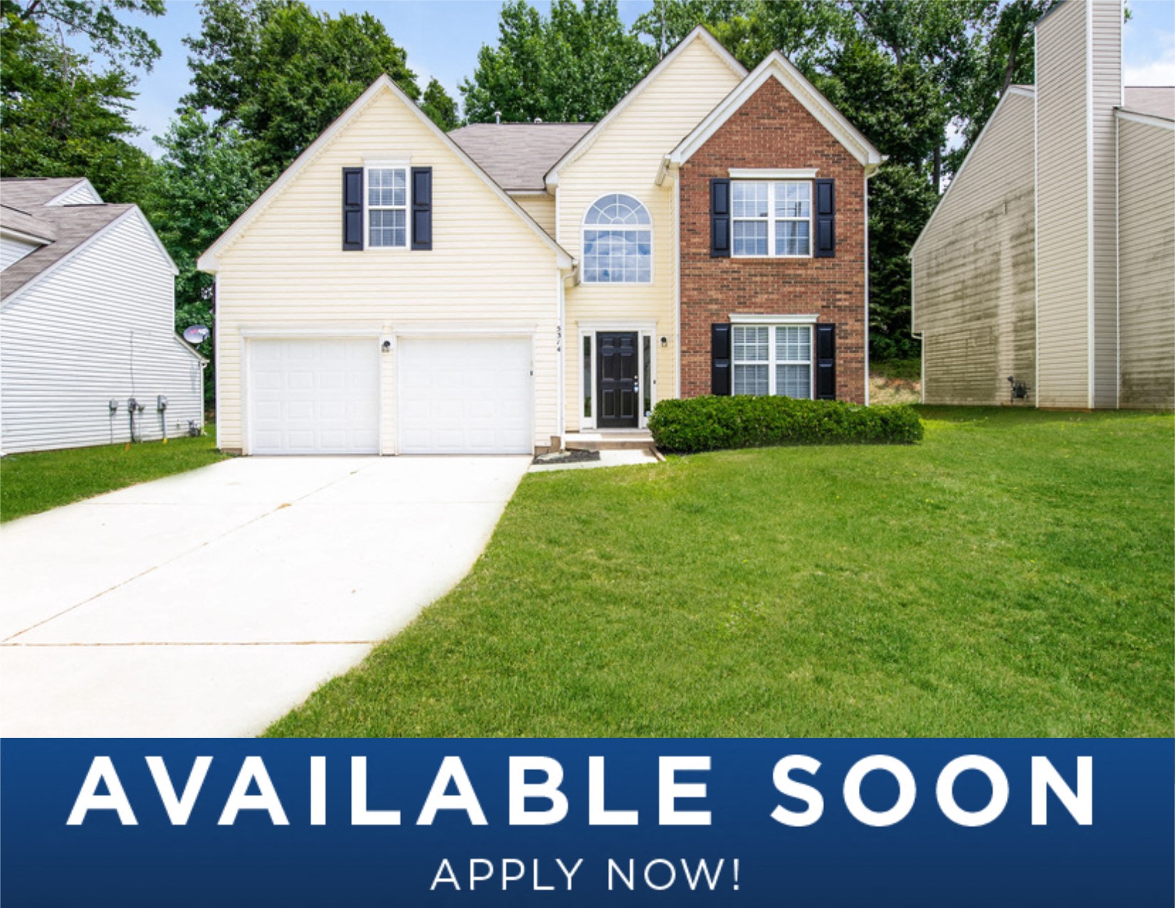 a white house with a lawn and a driveway