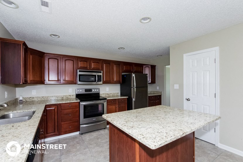 a kitchen with granite counter tops and stainless steel appliances