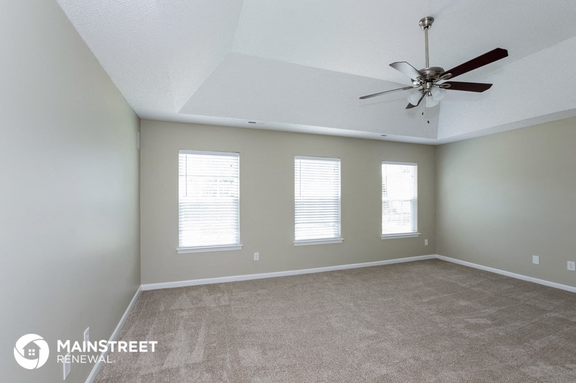 the living room of a home with a ceiling fan