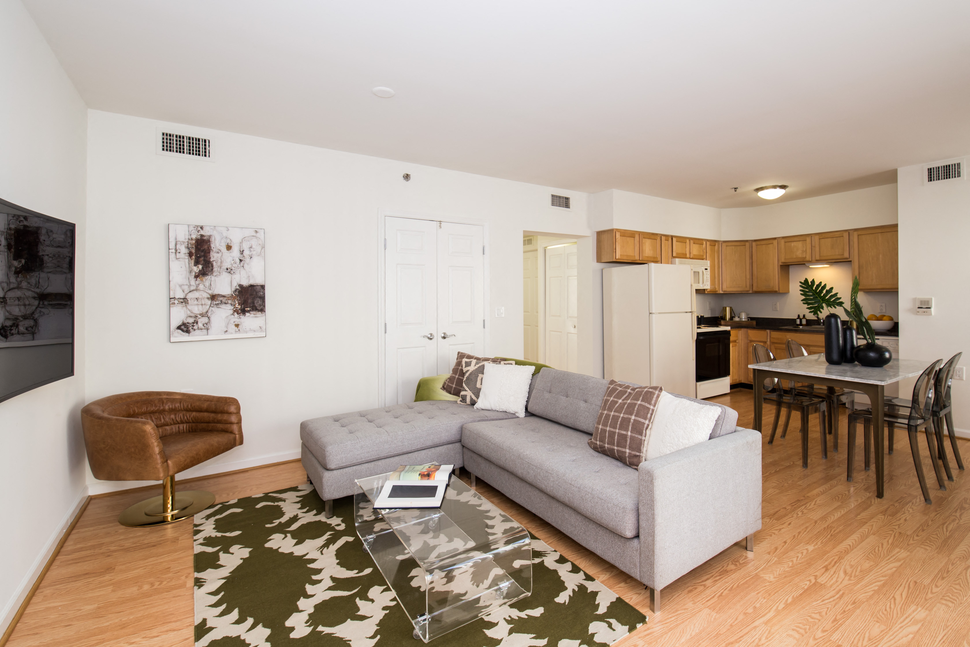 a living room with a couch and a glass coffee table