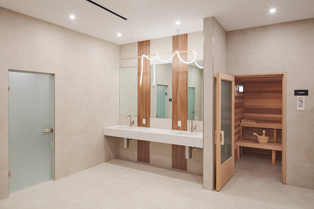 a bathroom with a sink and a mirror and a wooden closet