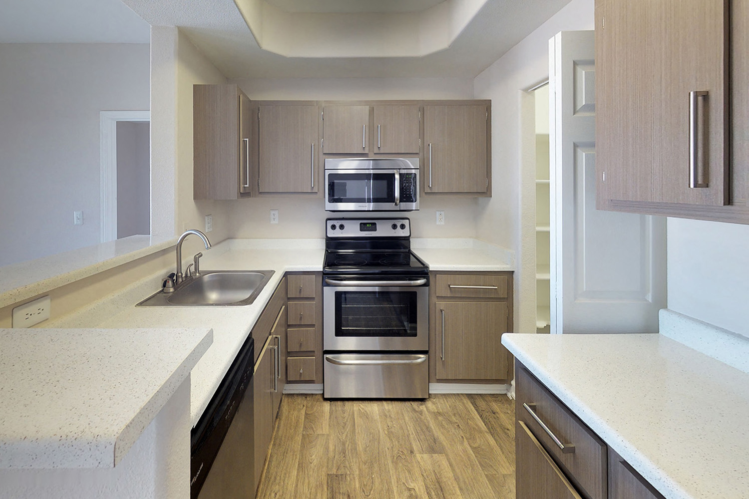 a kitchen with stainless steel appliances and white counter tops