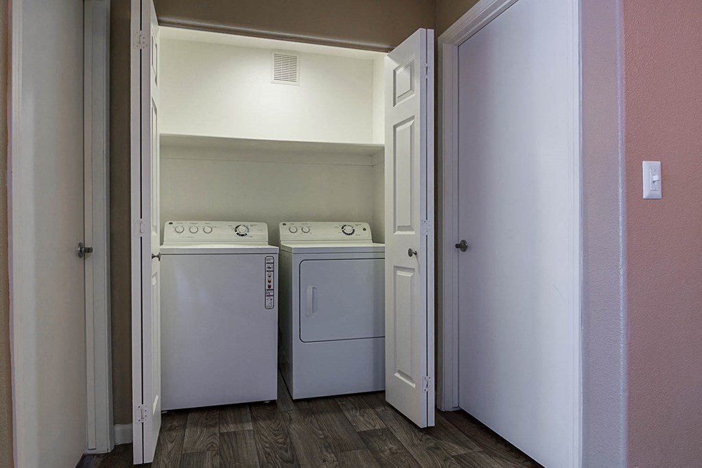 Laundry closet with full sized washer and dryer