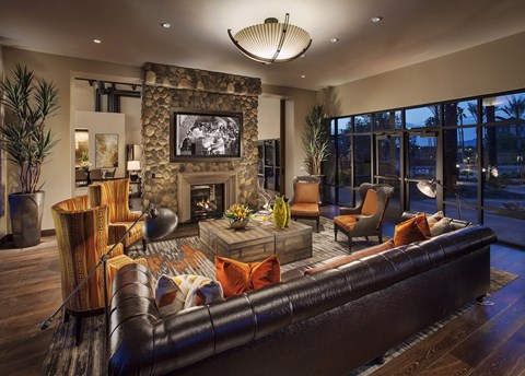 a living room with a leather couch and a fireplace