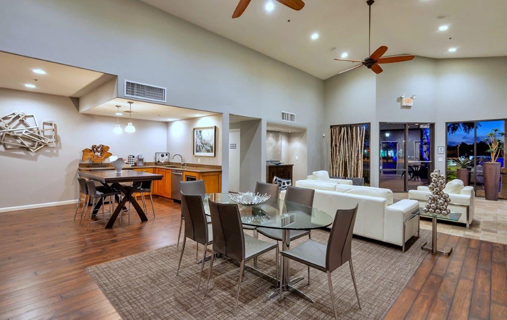 a living room and dining room with a table and chairs