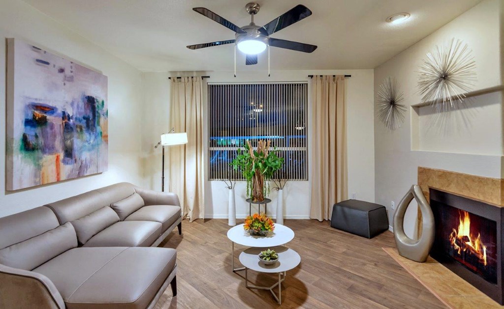 a living room with a couch and a ceiling fan
