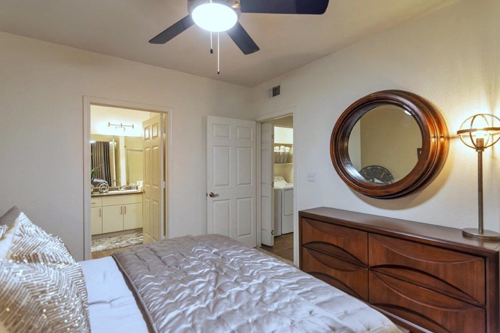 a bedroom with a bed and a ceiling fan