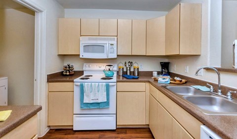 a kitchen with a stove microwave and sink