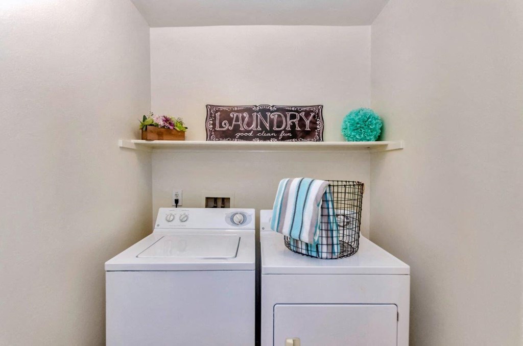a white washer and dryer in a laundry room with a white