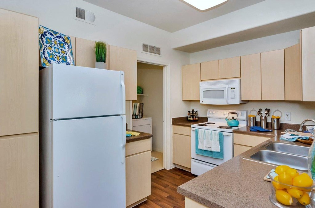 a kitchen with a refrigerator and a sink