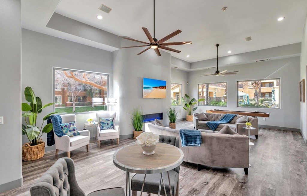 a living room with furniture and a ceiling fan