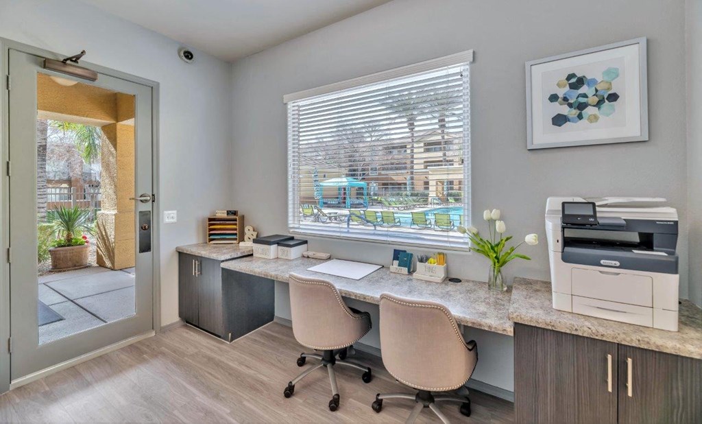 a home office with a printer and a desk with chairs