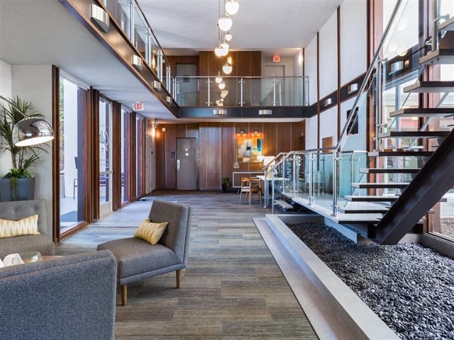 a living room with a spiral staircase and a lobby with furniture