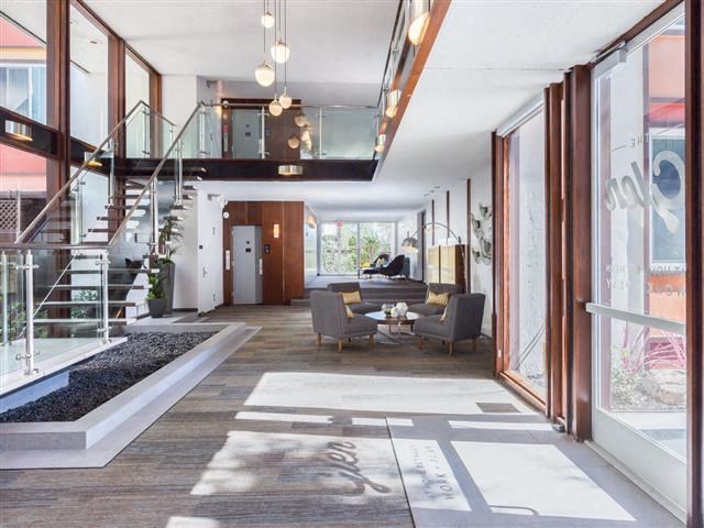 a living room with a staircase and a table and chairs