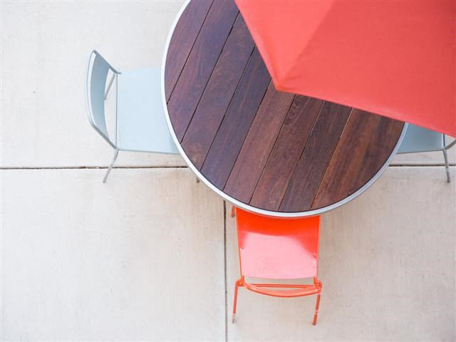 a table with a red chair and a round table