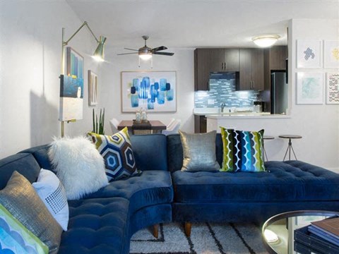 a living room with a blue couch and pillows