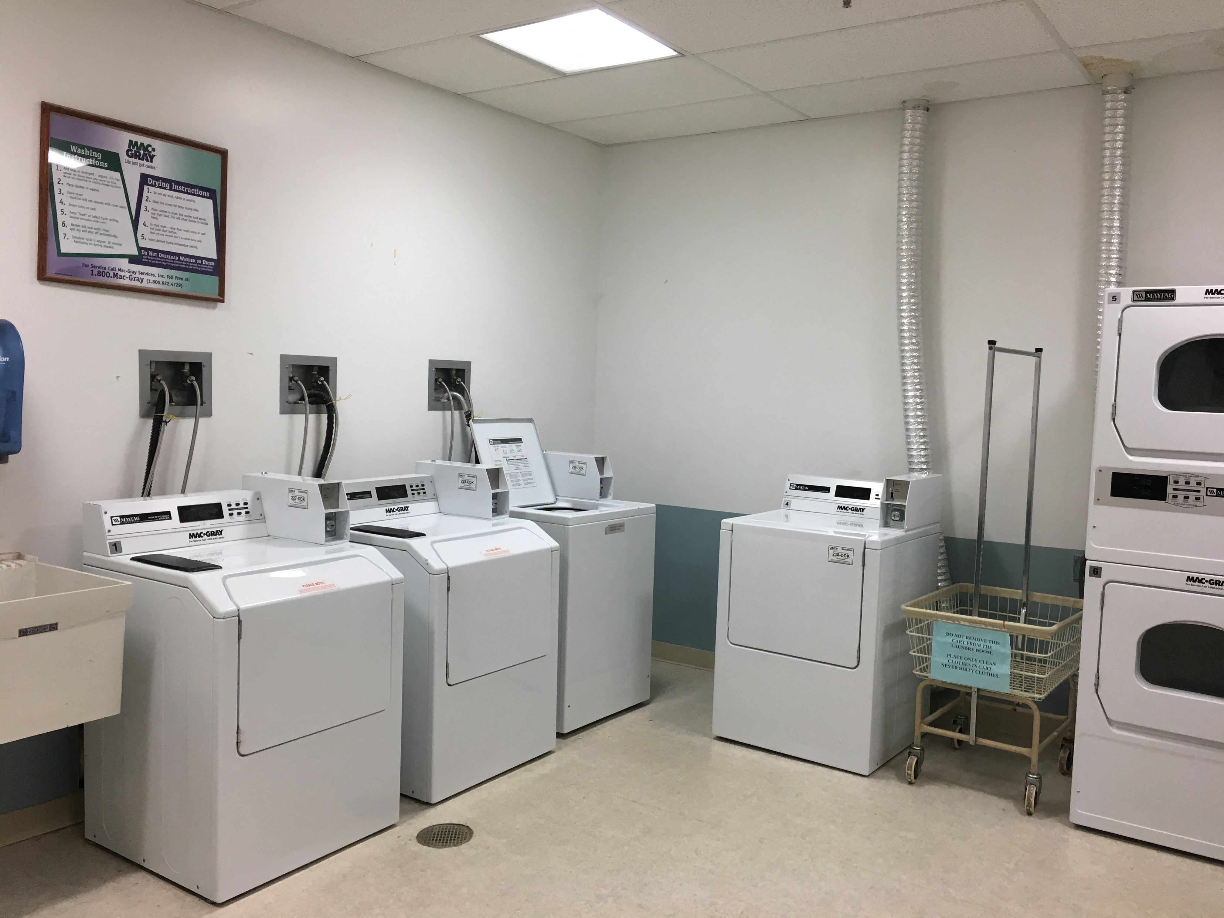 a row of washing machines in a laundry room