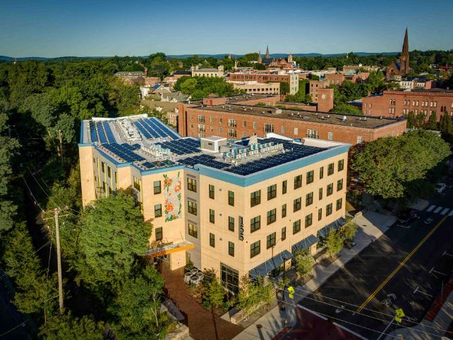 an aerial view of a building with a blue roof