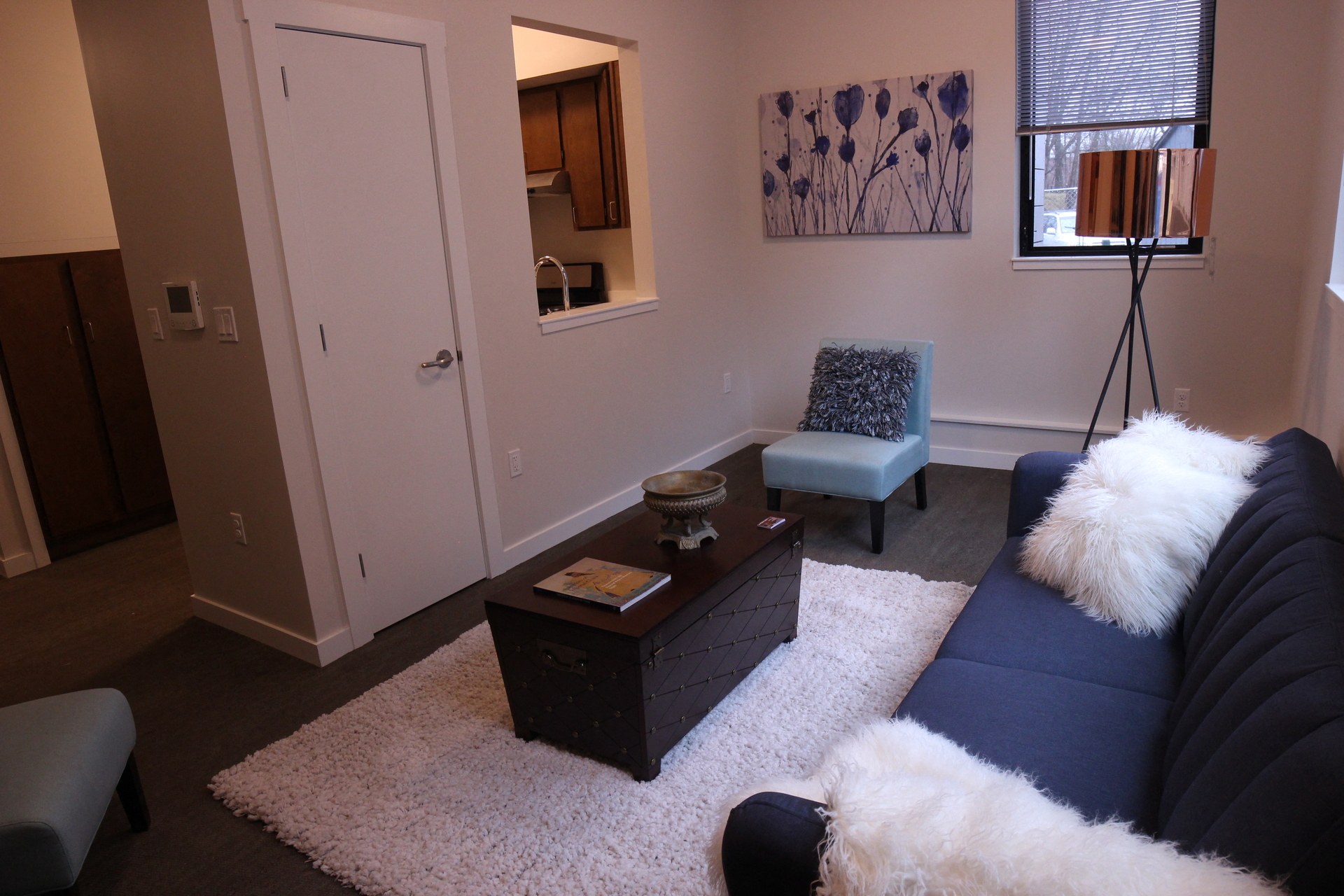 a living room with a blue couch and a chair