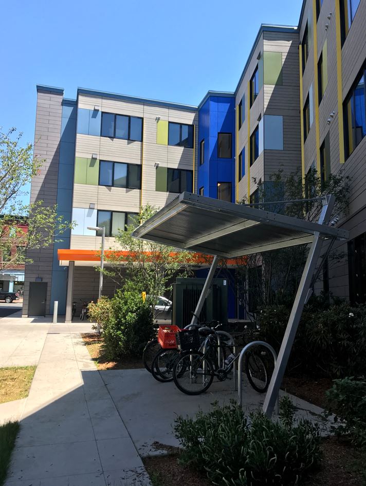 two bikes parked in front of an apartment building