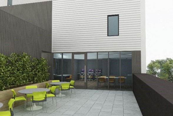 a patio with tables and chairs outside of a building