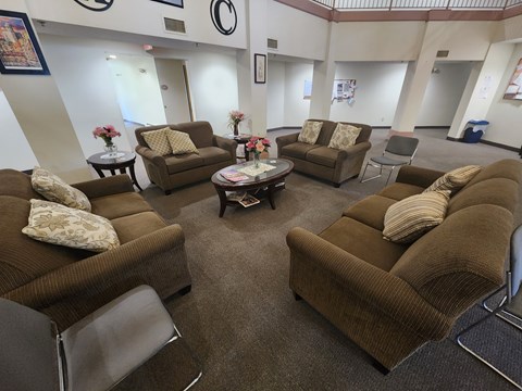 A living room with brown couches and a coffee table.