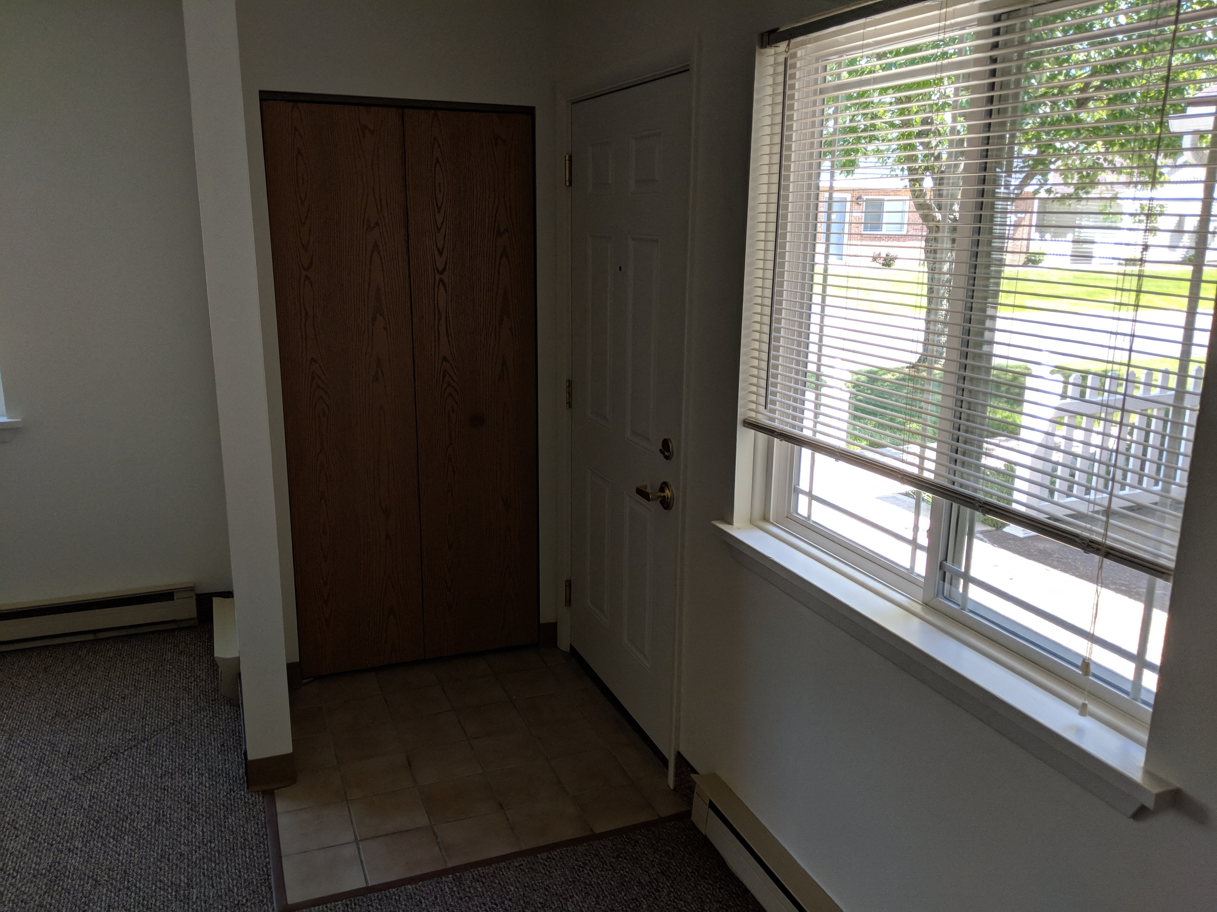 an empty room with a door and a window