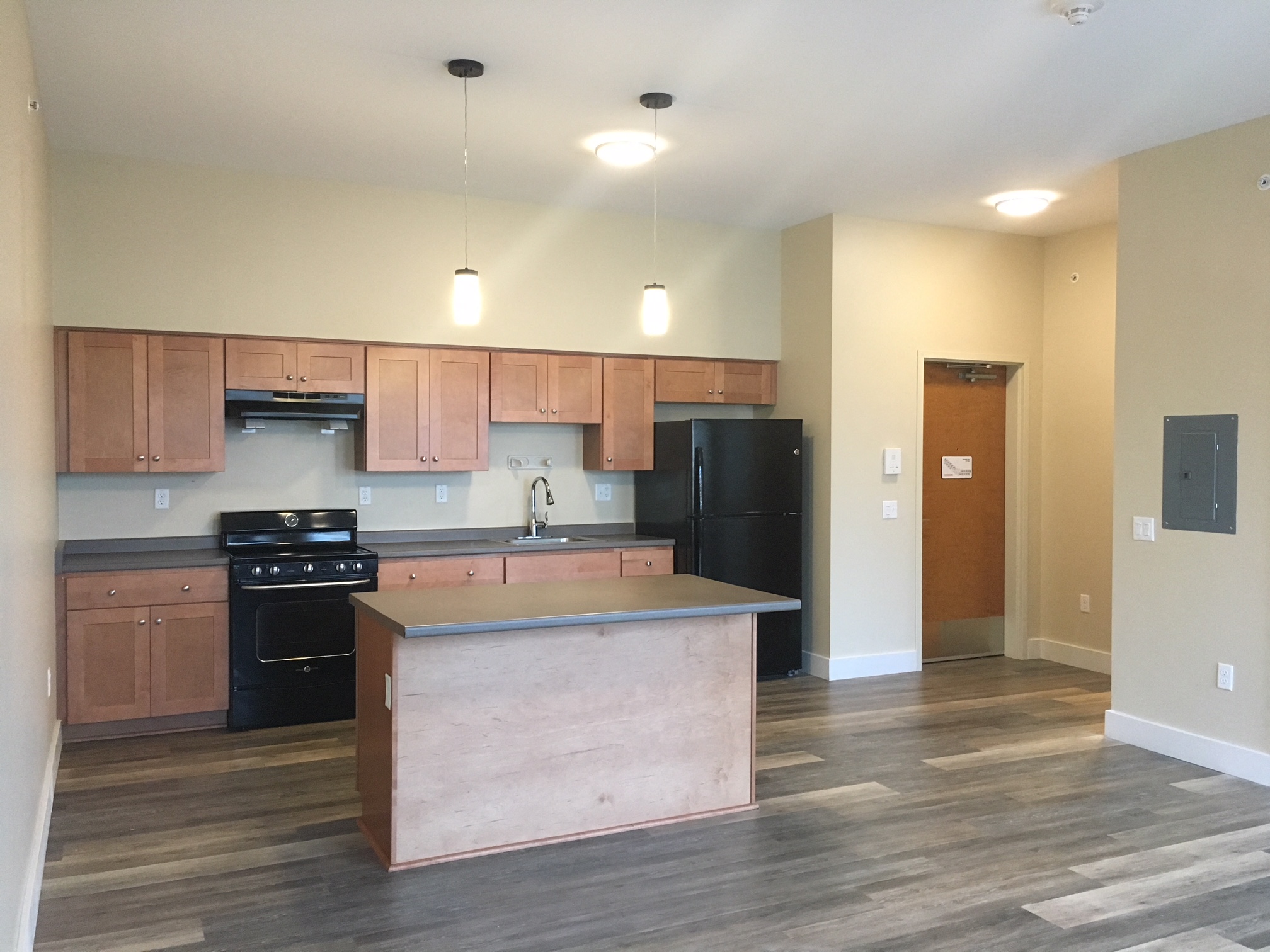 an empty kitchen with an island in the middle of it