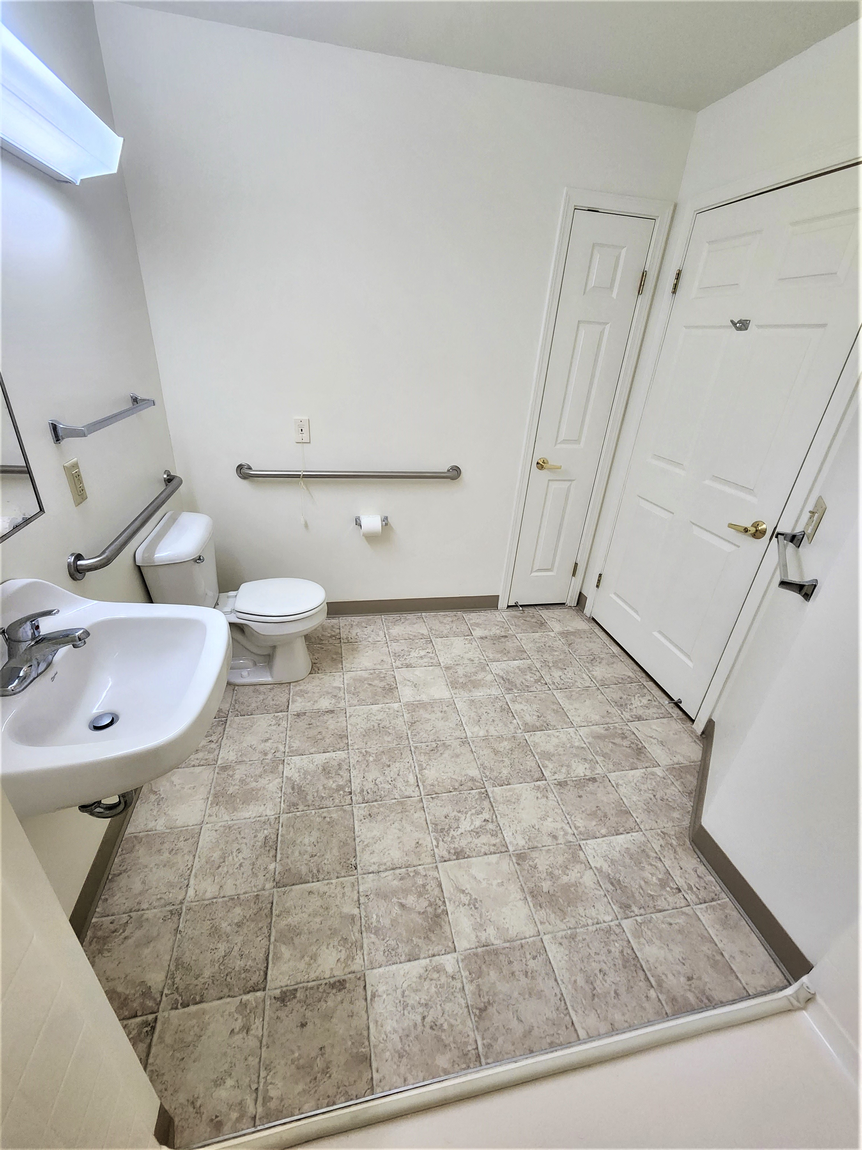 an empty bathroom with a toilet and a sink
