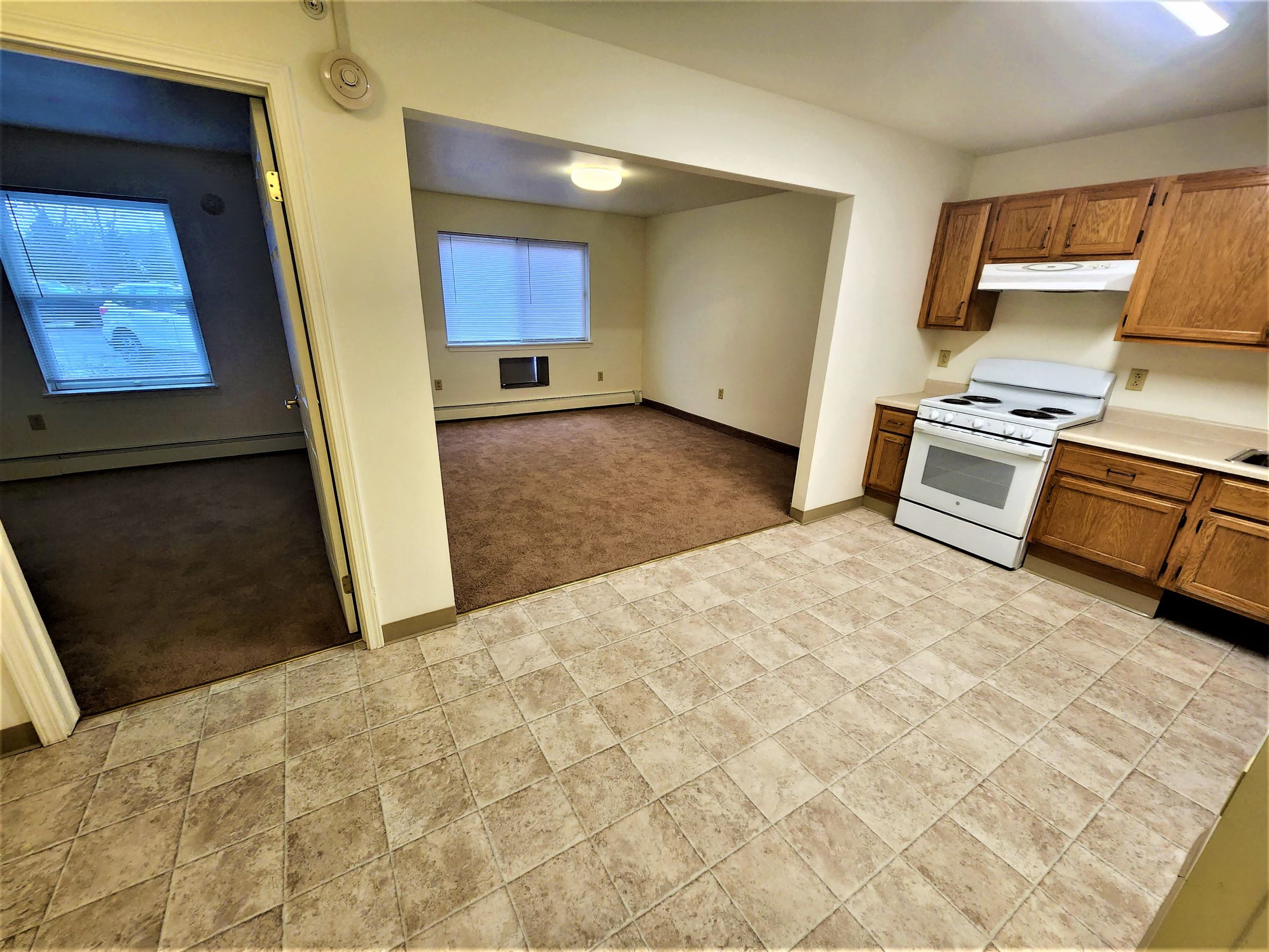 an empty kitchen with a stove and a sink