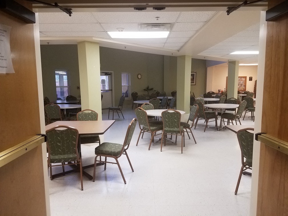 a dining room with tables and chairs in a hall