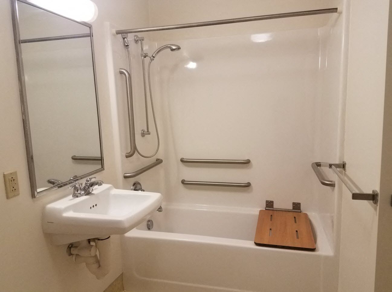 a bathroom with a sink and a bath tub and a mirror