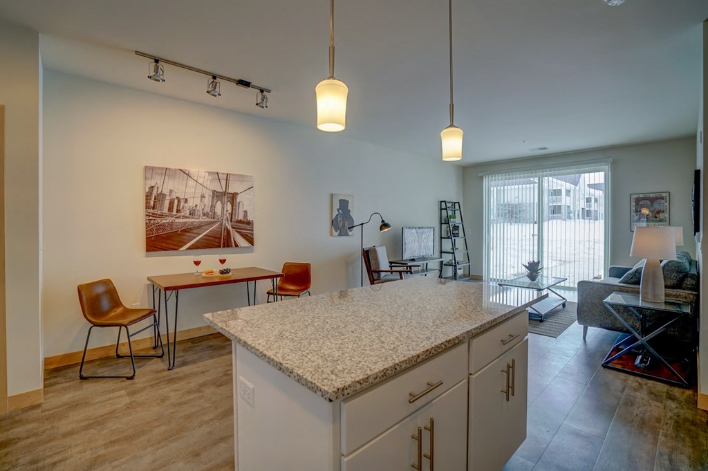 a kitchen with an island and a living room with a couch and a table