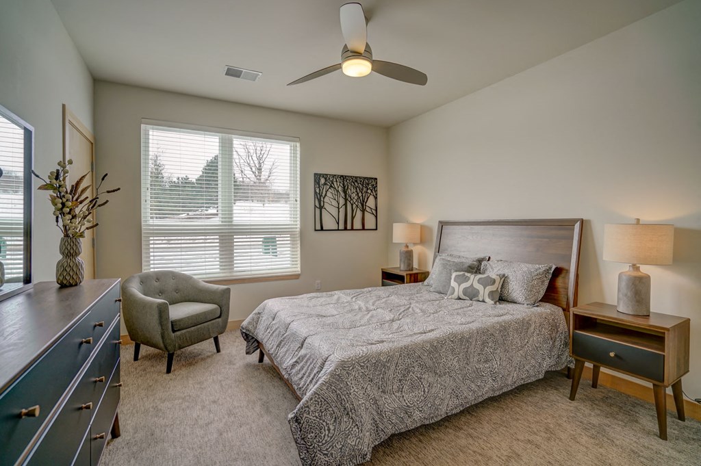 a bedroom with a bed and a ceiling fan