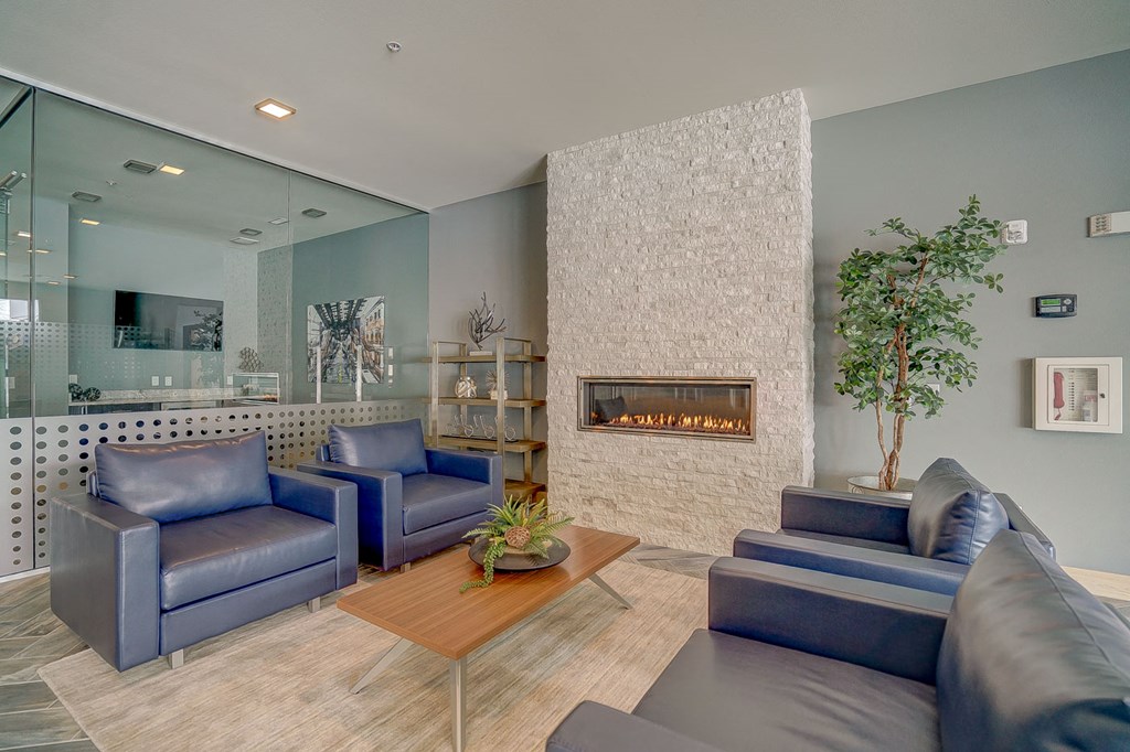 a living room with blue couches and a fireplace