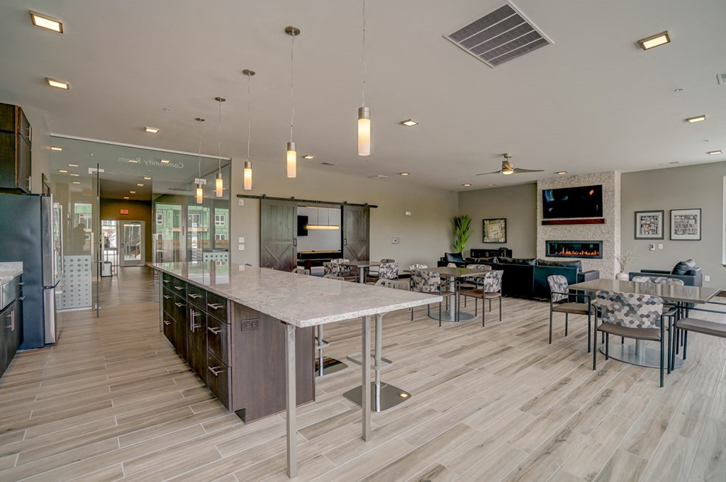 a large kitchen and living room with a table and chairs