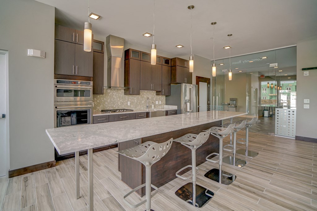 a large kitchen with a long island with chairs