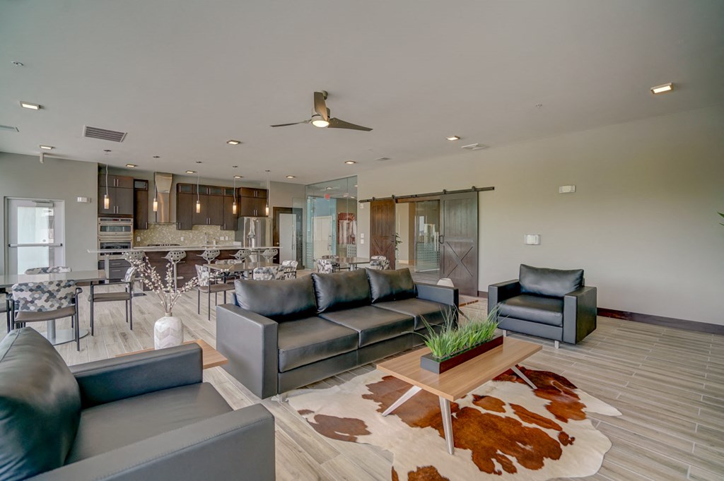 a living room with leather couches and a rug