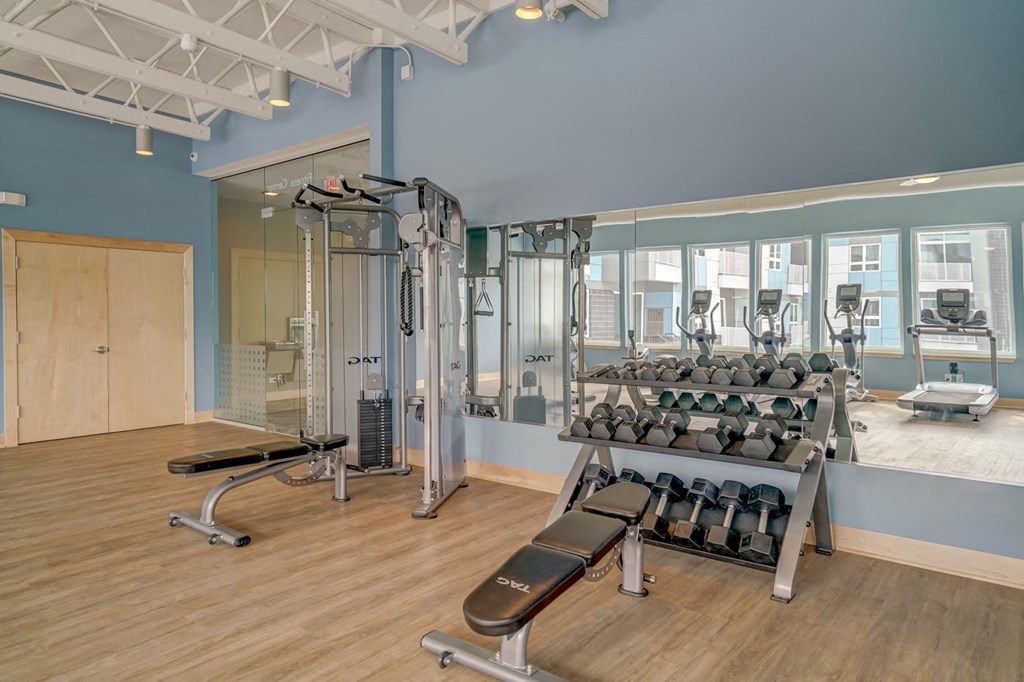 the residence apartments fitness room with weights and cardio equipment