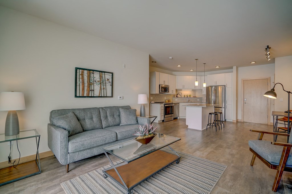 a living room with a couch and a glass table