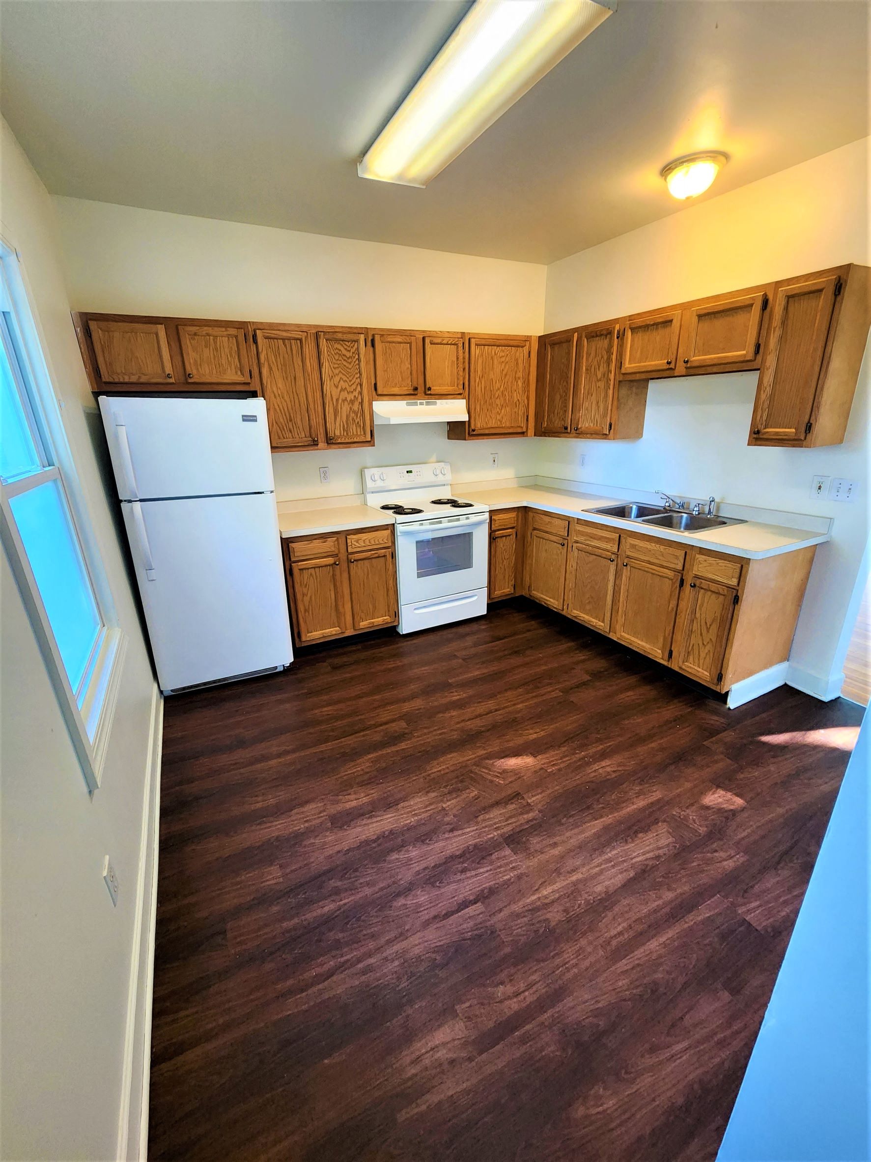 a kitchen with wooden cabinets and a white refrigerator