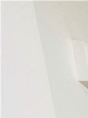 a hallway with white walls and a brown carpet