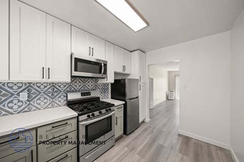 A kitchen with a stove top oven and a microwave above it.