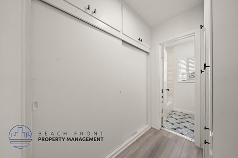 A white room with a doorway leading to another room.