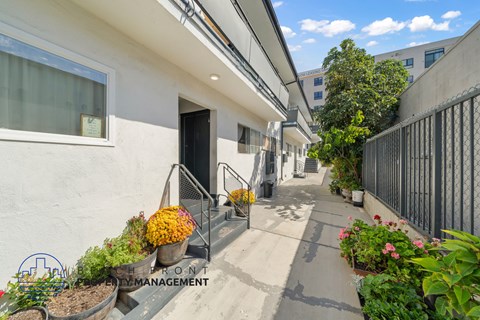 A building with a front yard and a sign that says Front Management.