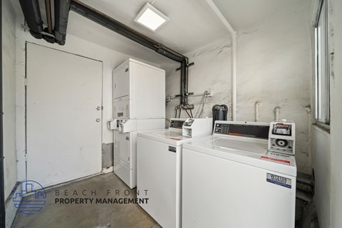 A laundry room with a washer and dryer, and a white door.